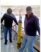 Photo of Ken Johnson and another scientist with an Apex float going for a test dive in Monterey Bay.