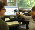 Photo of Carla Companion on left and Mary Jane Perry pointing to a webinar on the bloom.