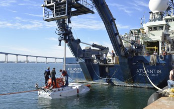 Researchers work on Alvin off the stern of the R/V Atlantis during sea trials off San Diego.