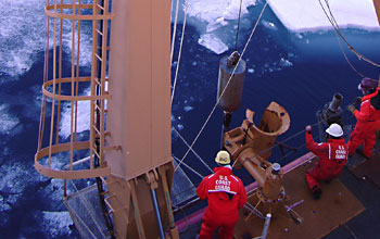 Researchers taking samples from a ship in the Arctic