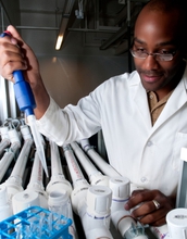 Student samples water in a lab