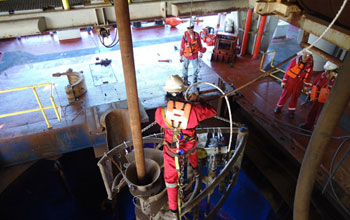 Photo of crewmembers preparing a low-light camera for a look at the Atlantis Massif.