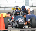 Photo of students working on their vehicle during SAE International's Formula SAE® competition.