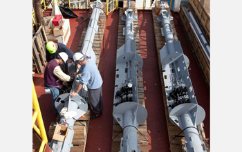 Photo of Bob Aduddell, Samuel Hulme and Geoff Wheat working on deck to prepare a CORK observatory.