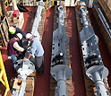 Photo of Bob Aduddell, Samuel Hulme and Geoff Wheat working on deck to prepare a CORK observatory.