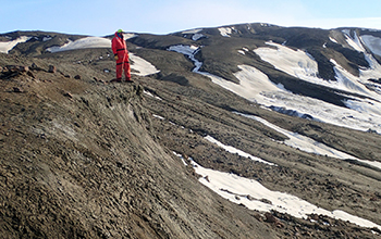 a Northwestern University researcher stands on the Lopez de Bertodano Formation