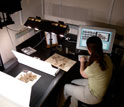 Photo of a researcher entering specimen images into a computer.