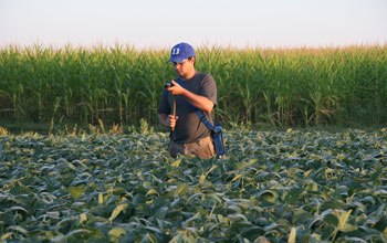 Photo of a scientist measuring plant responses to higher carbon dioxide.