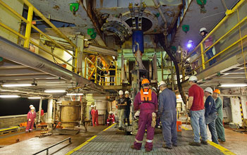 Photo of scientists and engineers beneath the rig floor.