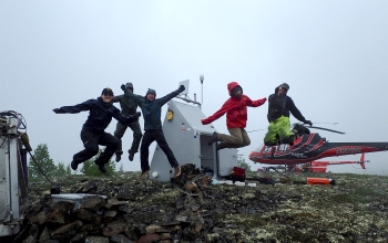 The Transportable Array field crew and helicopter pilots celebrate a successful installation.