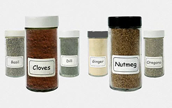 Jars of spices: basil, cloves, dill, ginger, nutmeg and oregano