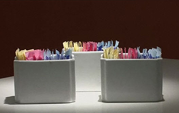 Containers of pink, yellow and blue packaged artificial sweeteners