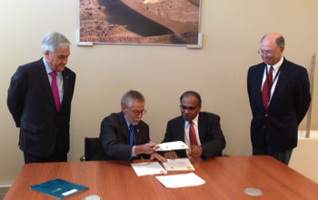 Sebastian Pinera, Jose Miguel Aguilera, Subra Suresh signing of the GROW agreement at a table.