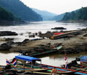 Photo of boats and people on the Salween river forming the boundary between Burma and Thailand.