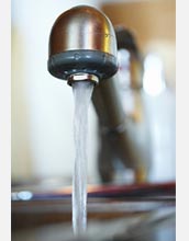 Photo of water coming out of a faucet.