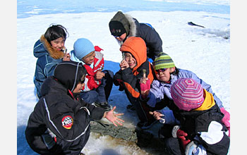 Photo shows group of children with 5000-year-old mud on snowy surface