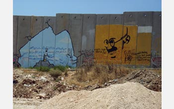 A drawing of Mahatma Gandhi on the wall separating the West Bank from Israel.