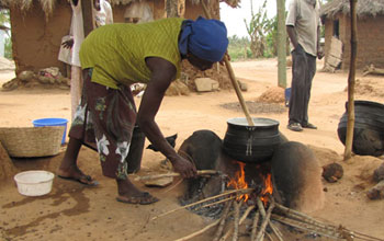 Woman cooking over an open fire