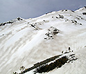 Photo of zebra stripes of dust and snow, visible on the snow surface in Colorado's mountains.