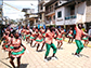 group of people dancing down a street