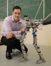 AMBER Lab Head Aaron Ames pictured with two-legged, humanlike robot