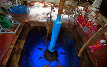 Photo of a recovery tool for sea-floor equipment rising through the ship's moonpool.