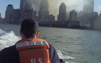 coast guard member looking at city skyline