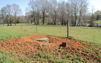 Photo  of a vault containing the tightly sealed seismometer and electronics and covered with dirt.