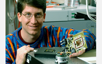Photo of Steve Potter holding a device that creates a neural network - computer interface.