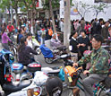 Photo shows e-bikes and people on a congested street