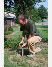 Researcher monitoring  lawn fertilization.