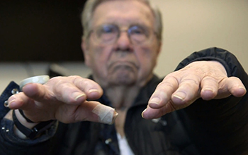 research study participant testing his hands for tremors