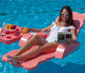 a woman in a bathing suit floating in a pool viewing a electrofluidic display technology.