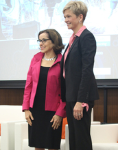 NSF Director France Córdova and Heidi Capozzi, Boeing senior vice president of human resources, stand together on a stage.