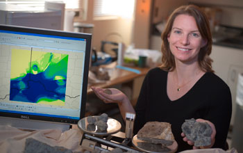 Photo of scientist Alycia Stigall on the right and a computer monitor on the left.