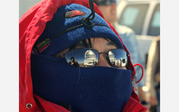 Gemini North reflected in the sunglasses of researcher Layne as she enjoys a crisp winter day.