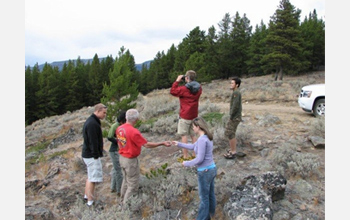 Photo of undergraduate and graduate students scoping out the landscape on a field trip.