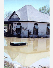 Photo of a house inundated by flooding.