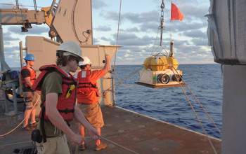 Deployment of an ocean bottom seismograph from the research vessel Thompson.