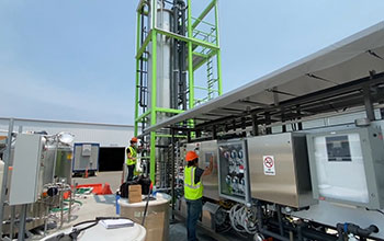 a construction worker standing at a machine