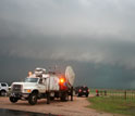 Photo of geoscientists using Doppler-on-Wheels to study tornado formation.