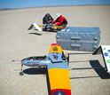 Research team members making adjustments to AUAVs, which carry miniature instruments.