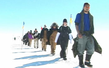 A line of students walking on Greenland's ice sheet.