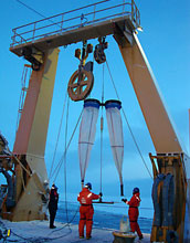 Photo of people deploying sampling nets from the stern of the Healy.