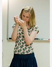 Photo of student scraping colonies off an agar media plate