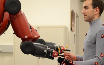 The Baxter robot hands off a cable to a human