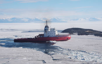 Photo of the Russian icebreaker Vladimir Ignatyuk breaking a path in sea ice in Antarctica.