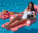 Photo of a woman in a lounge chair in a swimming pool watching an electrofluidic display.