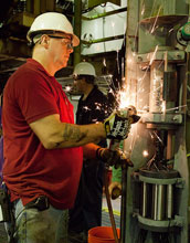 engineer Dan Slobodzian grinding rough edges on a CORK observatory before its installation.