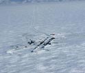 Photo showing an aerial view of the camp on shore, 100 kilometers north of the Arctic Circle.